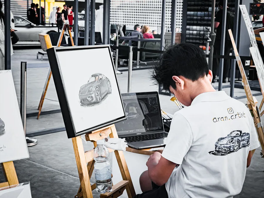 Artist sketching Porsche at event