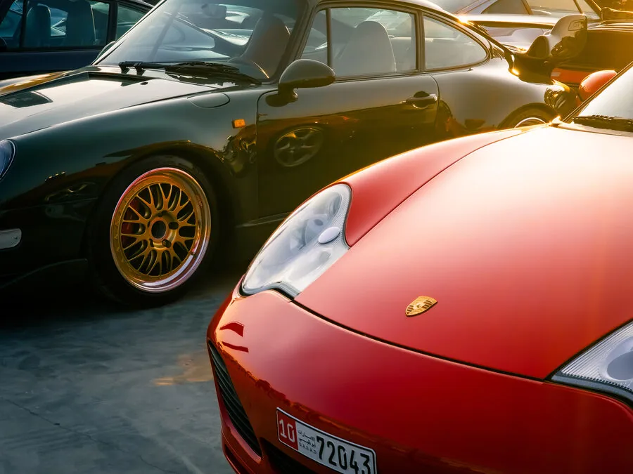 Red and green Porsche duo at golden hour